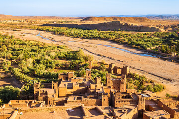 View of Ksar Ait Ben Haddou, old Berber ancient village or kasbah with desert in background,...