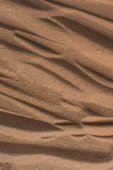 Lines drawn in brown sand background, beautiful sand texture, overhead view of chocolate brown sand, zen pattern drawn in the sand, Top view of fine grain texture