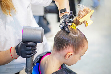 stylist does a girl's hair before entering a ballroom dancing tournament