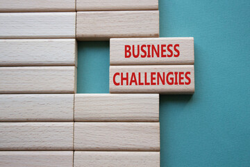 Business challenges symbol. Concept word Business challenges on wooden blocks. Beautiful grey green...