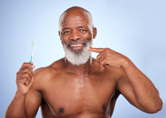 Point, oral hygiene and toothbrush for black man, mouth and studio for dental healthcare on blue...