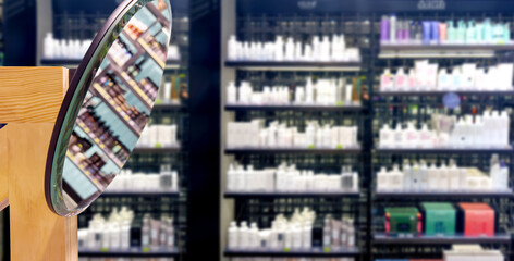 buying make up at cosmetics section in store. choosing cosmetics, perfumes, creams and shampoos