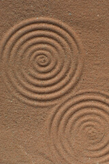 Lines drawn in brown sand background, beautiful sand texture, overhead view of chocolate brown sand, zen pattern drawn in the sand, Top view of fine grain texture