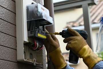 Electric meter replacement work. In Japan, electricity meters are replaced for free by power...