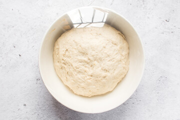 Plastic wrap covered bread dough that has doubled in size , dough that has fermented, proofed dough...
