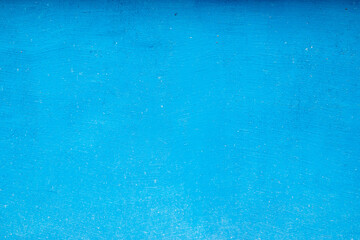 Blue painted house facade wall closeup as blue grunge background