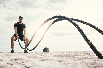 Fitness, with battle rope on beach for endurance challenge, strength or core training in outdoor....