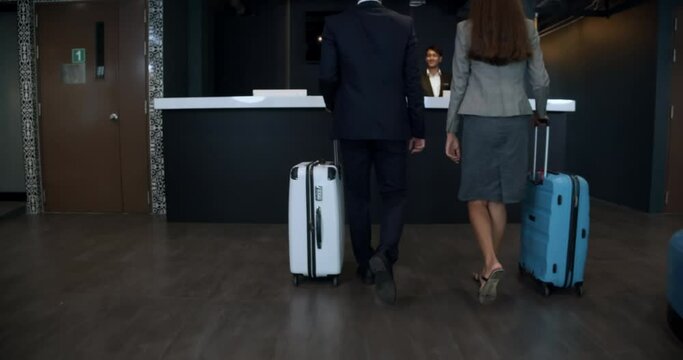 A Group of tourist check in at reception and going to the room to take a rest.
