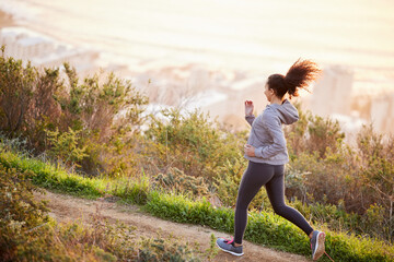 Woman, fitness and running in nature path for endurance challenge, marathon training or morning...