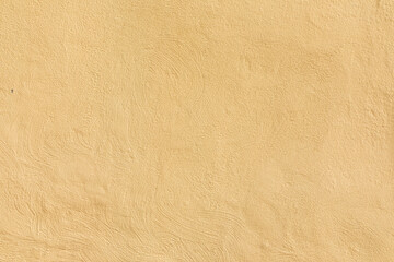 pattern of textured plaster wall in yellow