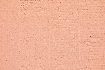 pattern of textured plaster wall in pink