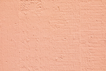pattern of textured plaster wall in pink