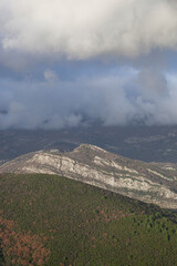 Spring in the mountains, beautiful mountain landscape. View of the mountain range and green trees. Summer, autumn and winter. Budva, Montenegro. Europe. Background. For text. Banner. Postcard. Vertica