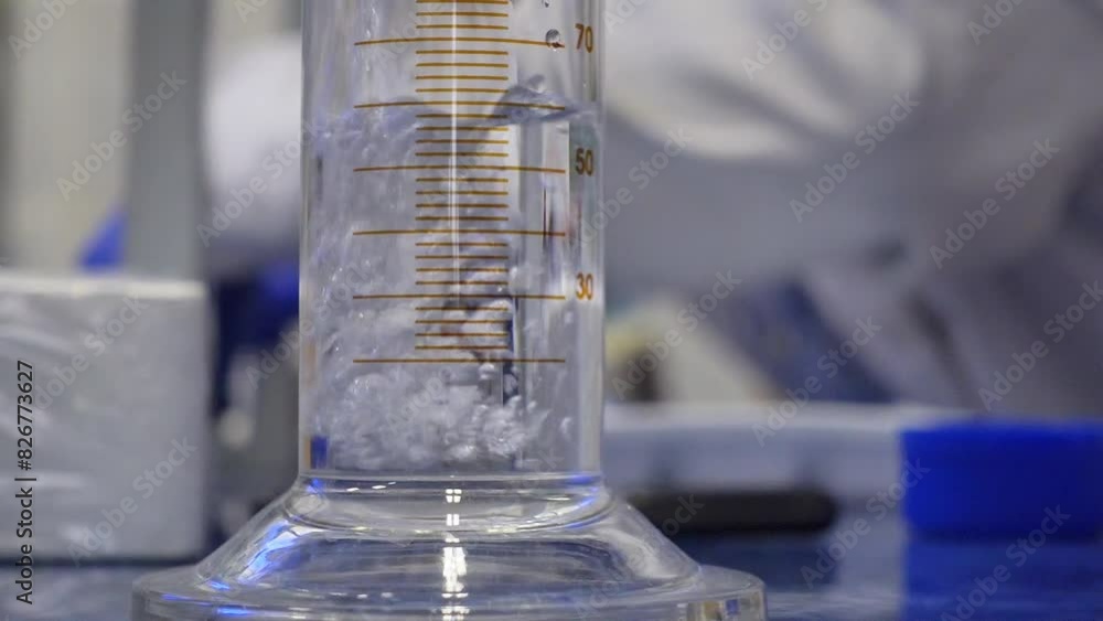 Canvas Prints A clear liquid is poured into a graduated cylinder in the laboratory.