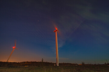 Aurora northern Lights in Estonia in Paldiski in a field with a wind generators.