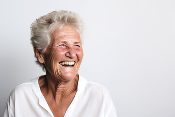 A joyful elderly woman with white hair is genuinely laughing, her eyes cheerfully crinkled and head tilted back slightly, showcasing a moment of happiness - Generative AI