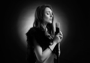 Beautiful singer with microphone, black and white effect