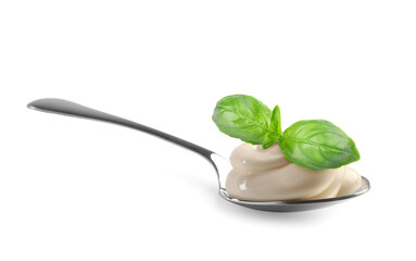 Spoon with delicious yogurt and basil isolated on white