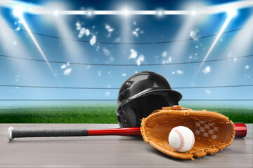 Baseball bat, glove, helmet and ball on wooden table at stadium