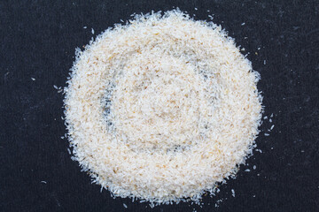 Psyllium husk or isabgol husk on black background close-up view 