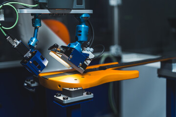 Paint control - using robot arm, closeup, musical instrument quality concept, factory acceptance testing FAT. High quality photo