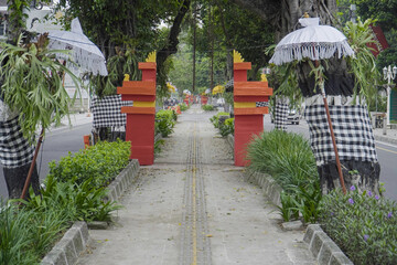 Background of a gate on the sidewalk with the concept of a decorative garden and umbrella