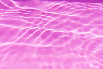 Purple water bubbles on the surface ripples. Defocus blurred transparent pink colored clear calm...
