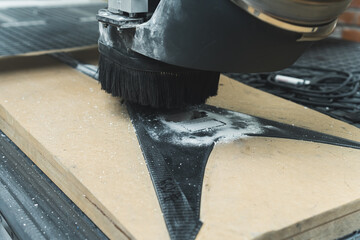 closeup shot of a milling machine working on carbon fiber guitar in the factory. High quality photo