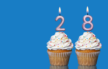 Birthday Cupcakes With Candles Lit Forming The Number 28