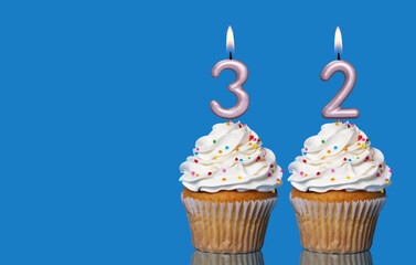 Birthday Cupcakes With Candles Lit Forming The Number 32