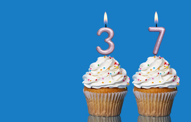 Birthday Cupcakes With Candles Lit Forming The Number 37