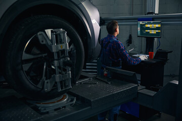 Male working with instrument for wheel repair