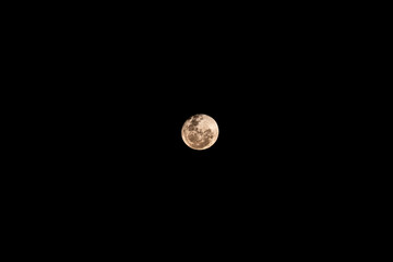 Full moon isolated on black background in the center of the frame