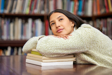 University, thinking and student with books in library for research, college project and learning....