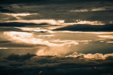 Golden Sunset Through Dramatic Clouds