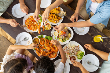 Happy Asian Multi-Generation family enjoy and fun spending time together having lunch eating...