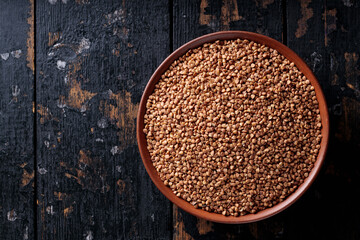 Dry Buckwheat Groats on Dark Wooden Background, Top View, Copy Space