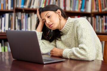 Library, university and woman on laptop tired with burnout for research, studying and learning. Education, burnout and exhausted student with computer for knowledge, information or project at college
