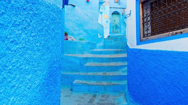 Medina alleys and stairs of Chefchaouen, the famous Blue Pearl of Morocco or Blue City. Chaouen is noted for its buildings in shades of blue, UNESCO heritage. Gimbal Prores cinematic panning - POV