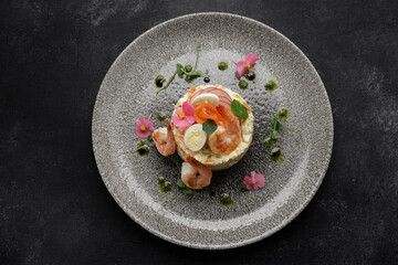 Olivier salad with salmon, shrimp. Traditional festive salad