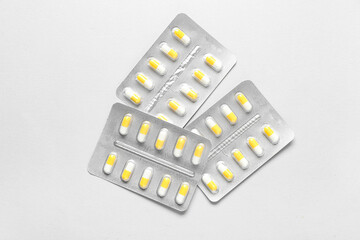 Blister packs with pills on white background