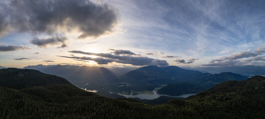 Dramatic Canadian Mountain Landscape Cloudy Sunset. Aerial Panorama Background.