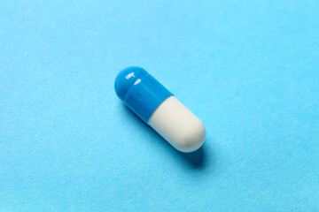 Colorful pill on blue background