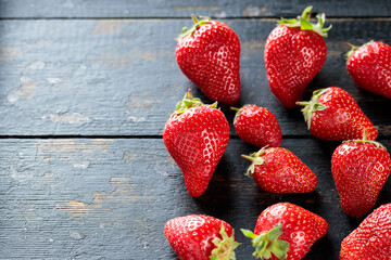 Fresh Ripe Red Strawberries Scattered On Rustic Dark Wooden Surface, Top View, Copy Space