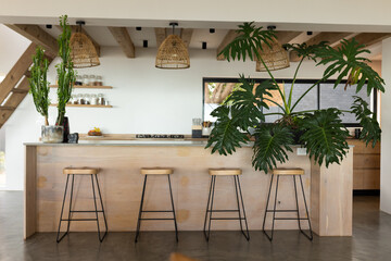 At home, three stools standing in front of wooden bar counter