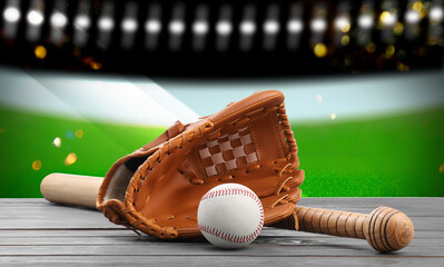 Baseball bat, glove and ball on wooden table at stadium, banner design
