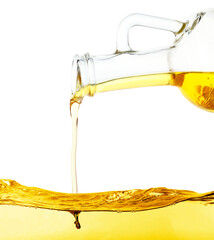 Pouring cooking oil from jug on white background, closeup