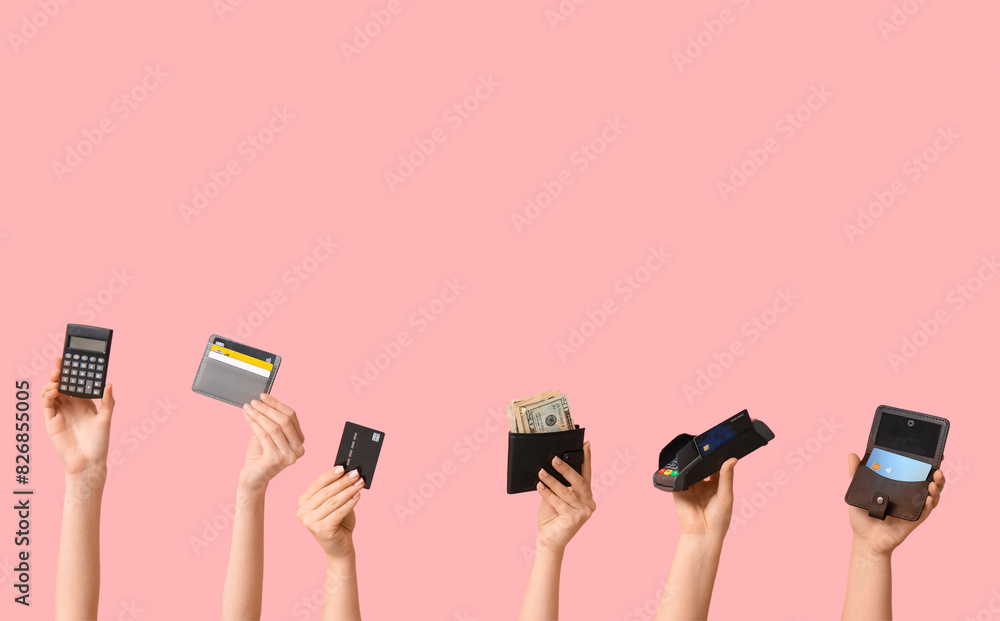 Poster female hands with credit cards, wallet, calculator and payment terminal on pink background