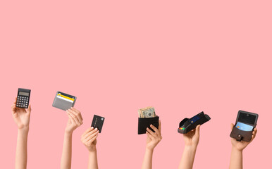 Female hands with credit cards, wallet, calculator and payment terminal on pink background