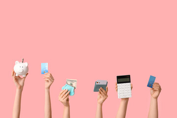 Female hands with credit cards, calculator, wallet and piggy bank on pink background